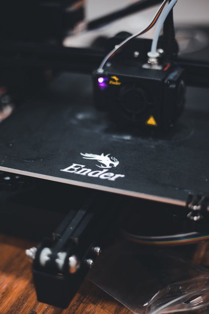 Detailed view of a 3D printer working on a design with the Ender brand logo visible.